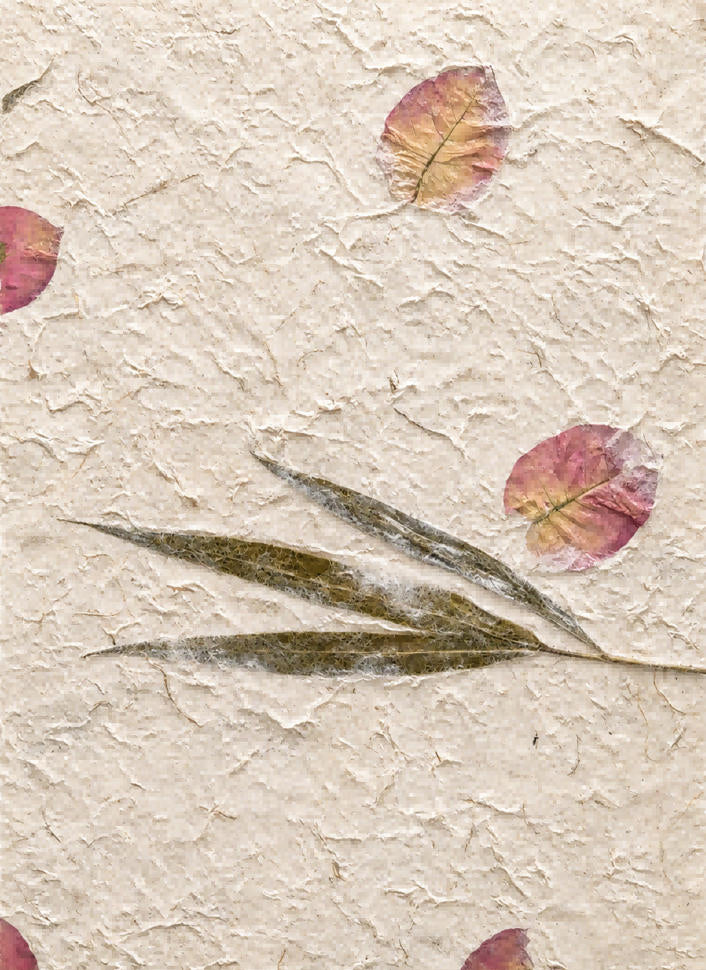 Handmade botanical paper with pressed bamboo leaves, red flowers and a naturally textured surface