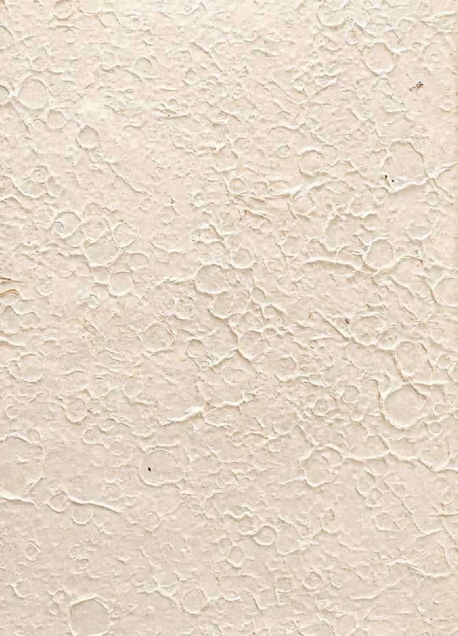 White handmade art paper with an irregular moon rock pattern and raised stone-like texture