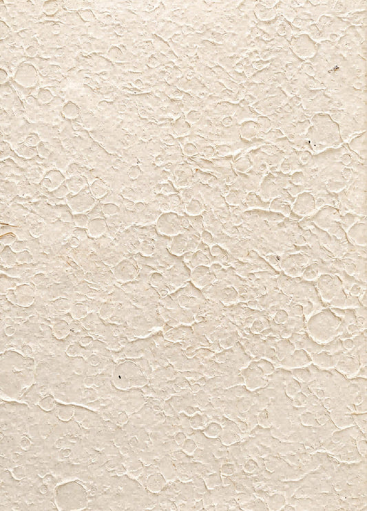 White handmade art paper with an irregular moon rock pattern and raised stone-like texture